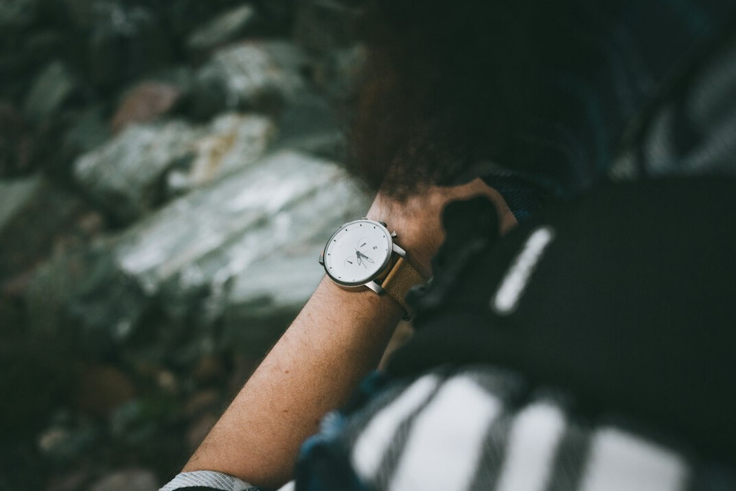person checking watch in queue