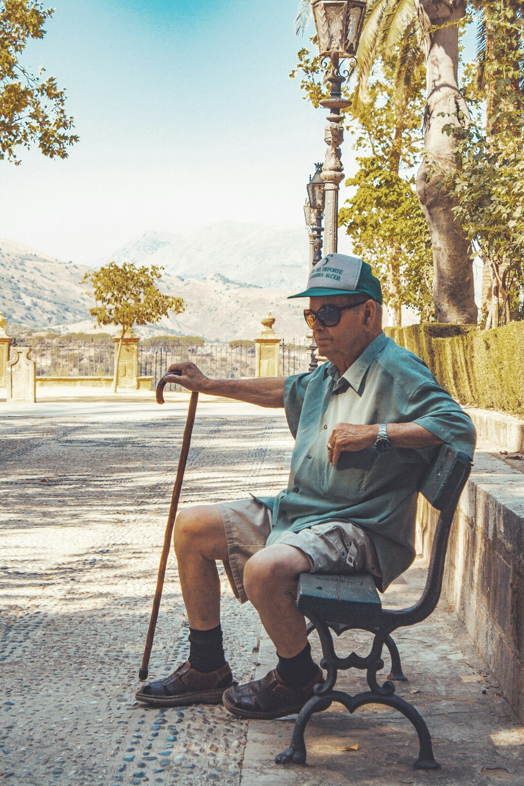 elderly person waiting on bench