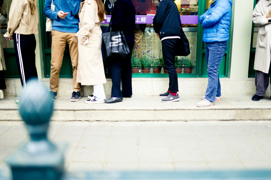 people waiting in city queue