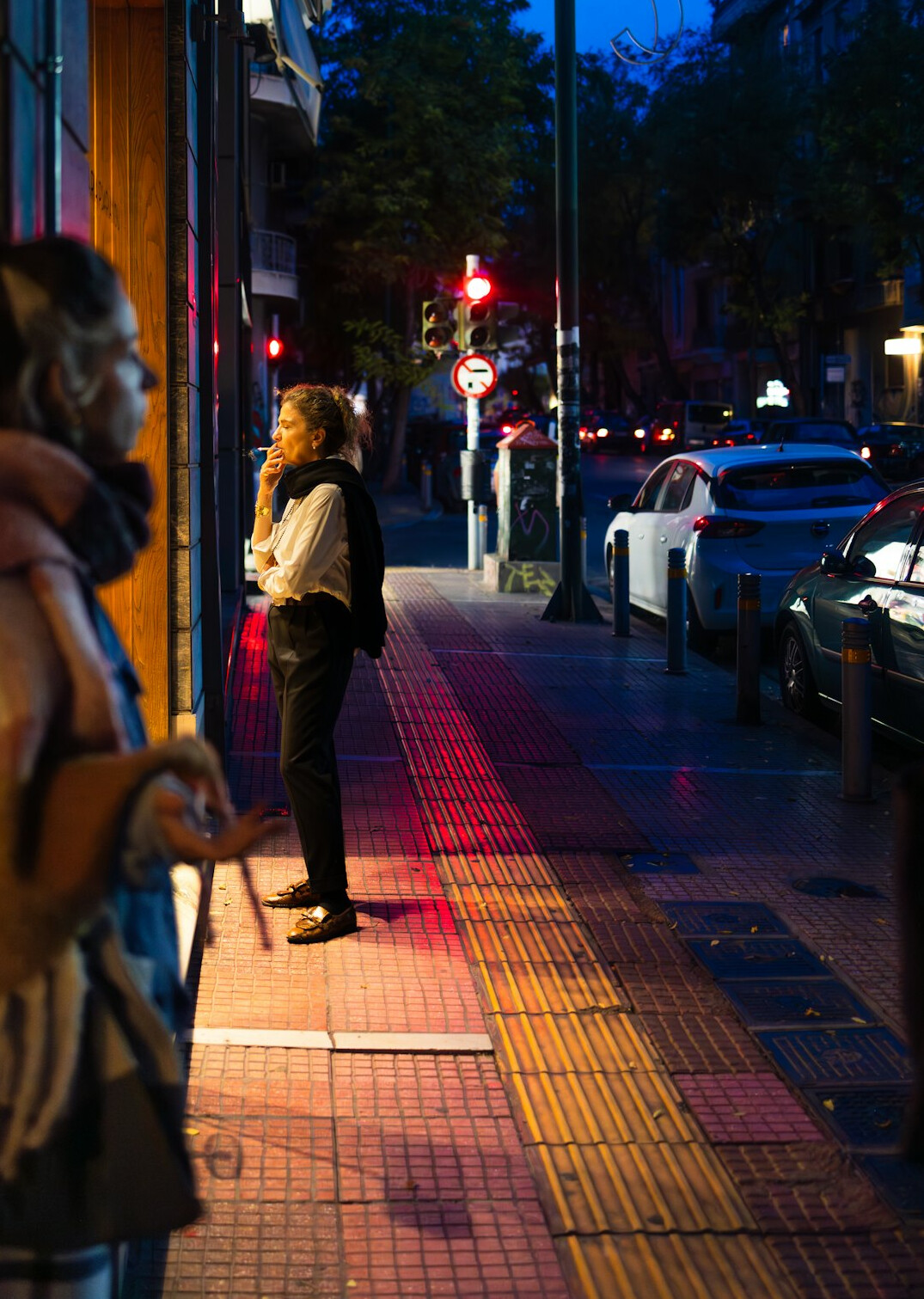 people waiting in line on city street