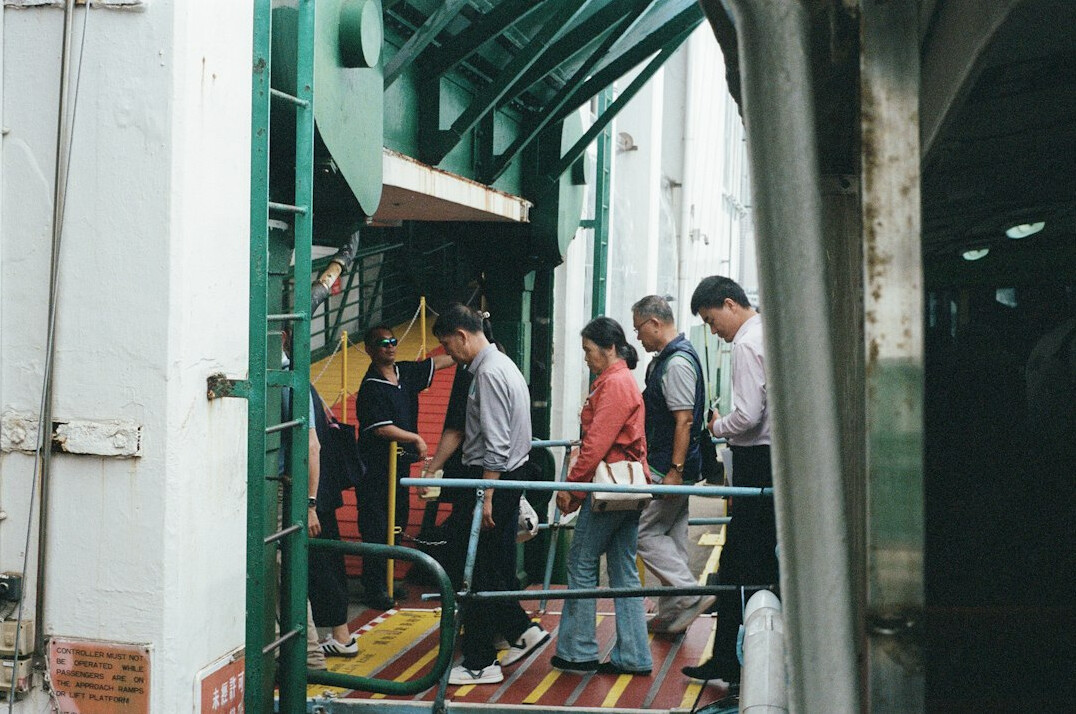 people waiting in line on city street