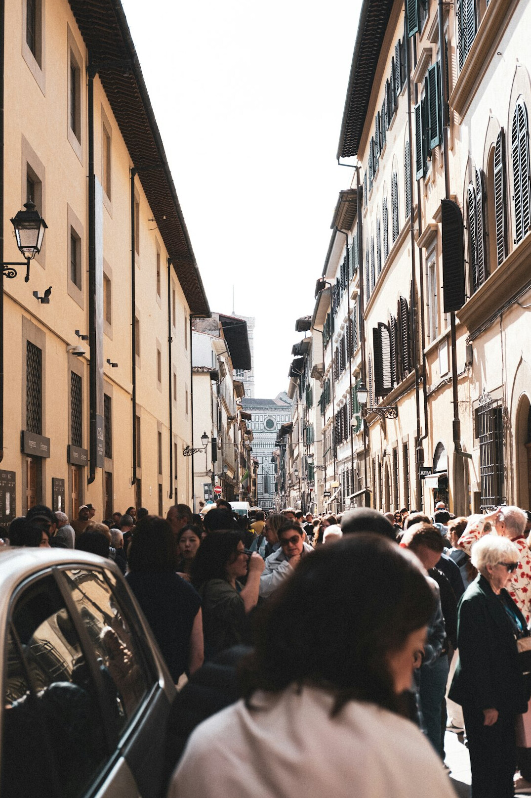 people waiting in line on city street